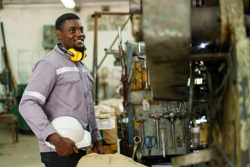 African black male engineer portrait in factory.