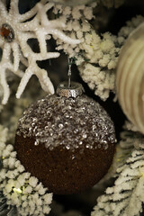 Festive Christmas Ornament on a Snowy Tree with Sparkling Details