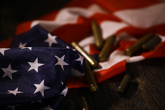 American Flag with Bullet Casings - Symbolism of Patriotism and Conflict