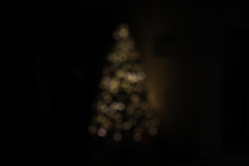 Blurred Christmas Tree Lights in Dark Room During Holiday Season