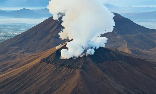 Aerial view of active volcano with crater in depth. Brown dirt around. clouds of smoke on volcano, Mount Bromo, Indonesia