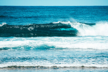 A beautiful wave breaking into a perfect surfing barrel wave, crystal clear wave in the world famous surfing spot at Cloud 9 Beach, Siargao Island, Philippines.