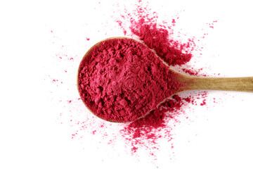 Pile of acai powder in wooden spoon, isolated on white background, top view