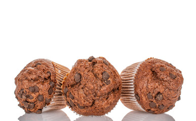 Three chocolate cupcakes, isolated on white background, close-up.