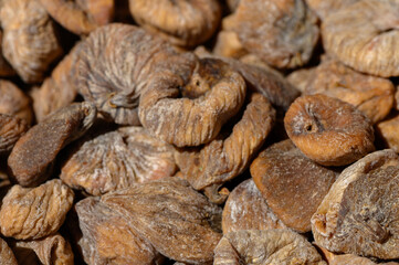 Dried figs displayed in sunlight highlighting their rich texture and natural sweetness in a vibrant marketplace