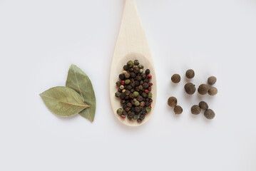 bay leaf aromatic pepper and pepper mix in wooden spoon