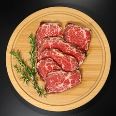 Fototapeta premium A piece of meat with a bunch of herbs on top of it