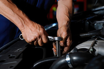 Man master repairs under the hood of the car