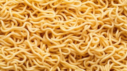A close-up overhead shot reveals a tangled mass of dried yellow instant noodles ready to be cooked for a quick and easy meal.