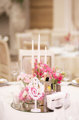 Wedding centerpieces with fresh flowers and candles. Wedding decorations. Wedding day.