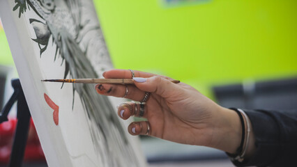 Woman Painting on Canvas with Brushes and Colors