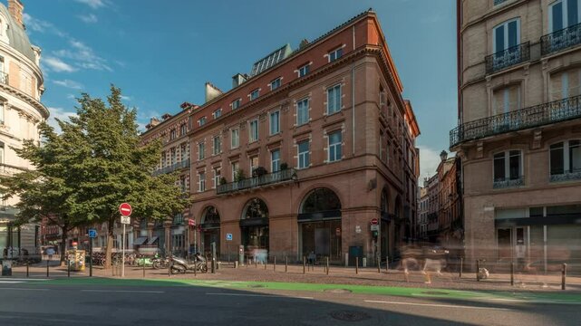Panorama showing Rue de Metz timelapse in Toulouse, Occitanie, France, with historic facades, shops, cafes, traffic and a blue cloudy sky. Vibrant urban scene in the heart of the city