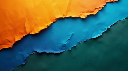 Vibrant hues of orange and blue meet in a dynamic interplay of torn paper.