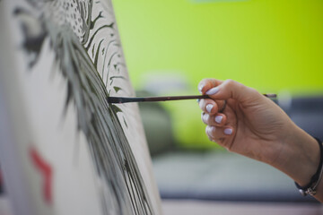 Woman Painting on Canvas with Brushes and colors