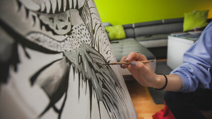 Woman Painting on Canvas with Brushes and colors