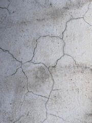 Deep cracks in the floor, close-up. Damaged floor, old surface. Signs of deterioration of the wall or floor covering in the building.