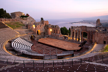 Teatro Antico di Taormina with view over the bay and Mount Etna in the background.  Remains of the...