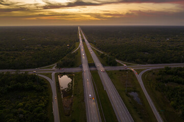 American highway bridge with fast moving traffic in evening. Interstate transportation concept