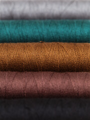 ull cross-wound spools of thin sewing tread