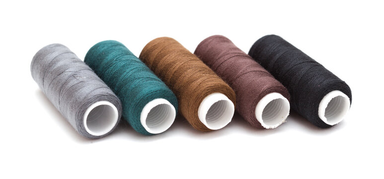 ull cross-wound spools of thin sewing tread