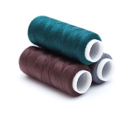 ull cross-wound spools of thin sewing tread