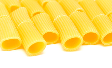 Rigatoni, tube shaped dry pasta with ridges, isolated on white background 