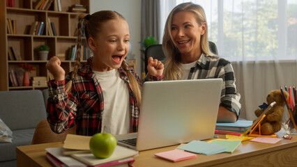 Glad caring Caucasian mother mom woman talk teaching use laptop kid girl typing success child schoolgirl learning at home family pupil female rejoicing high five parent celebrate daughter study online