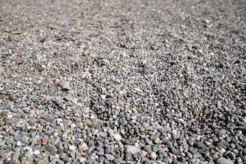 Close-up of small gray pebbles, showcasing texture with perspective. Perfect for backgrounds, nature themes, or designs highlighting natural patterns, stones, and organic elements.