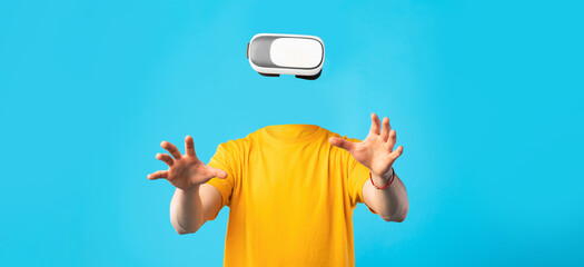 A user enjoys virtual reality using a headset, with no visible head or face. The individual hands...