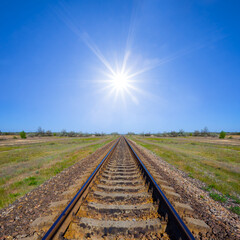 Fototapeta premium railway among green prairie at the sunny day