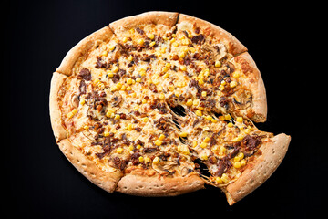 pizza with meat on a black background