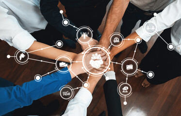 Hands come together in collaboration, symbolizing teamwork and digital connection in a professional setting, highlighting unity and innovation in business. Amity