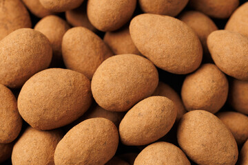 Chocolate coated almonds background. Cocoa coated almonds. Cocoa Dusted Almonds