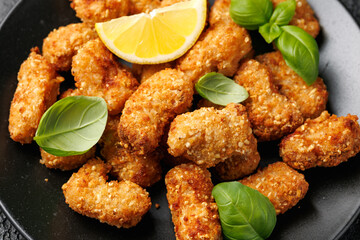 Crispy breaded scampi nuggets with sauce on plate
