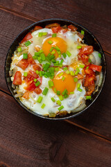 Shakshuka Jewish dish with egg, tomatoes and green onions