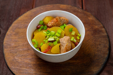 Chelnt with meat and beans Jewish holiday dish on a wooden table
