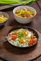 Set table, Jewish food, tzimmes, chelnt, shakshuka and couscous with dried fruits