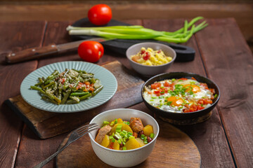 A set table, tzimmes, chelnt and couscous with dried fruits