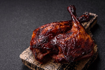 Duck, chicken leg or thigh grilled on a dark concrete background