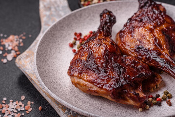 Duck, chicken leg or thigh grilled on a dark concrete background