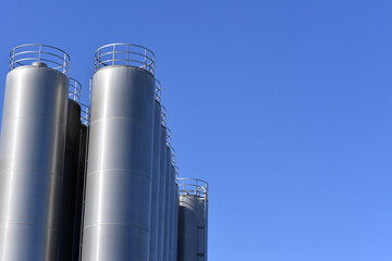 Silver steel silos, blue background, agricultural building