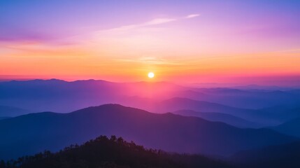 Obraz premium Mountain range at sunset with vibrant pink orange and purple