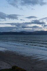 Beach at sunset overlooking mountains