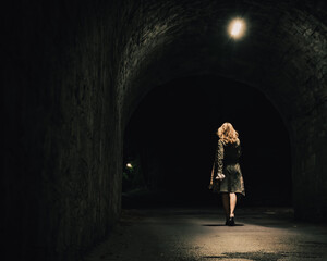 young woman walking in the tunnel