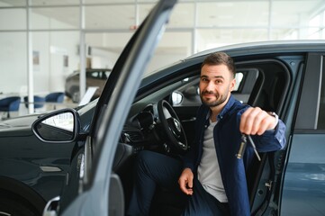 Obraz premium Man customer male buyer client chooses auto wants to buy new automobile