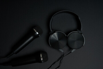 black microphone and headphones on a black background