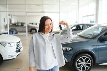 Happy friendly woman customer female buyer client chooses auto wants to buy new automobile