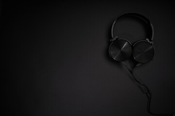 black headphones on a black background