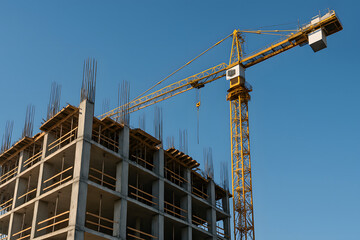 Fototapeta premium Construction Site with Crane and Building Framework