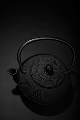 Black matal teapon on black background